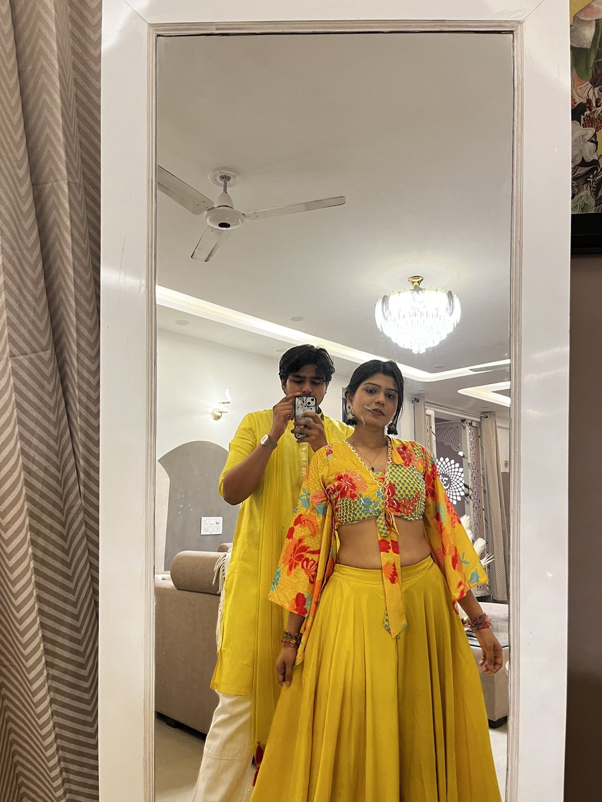 Akshat taking a mirror photo with family