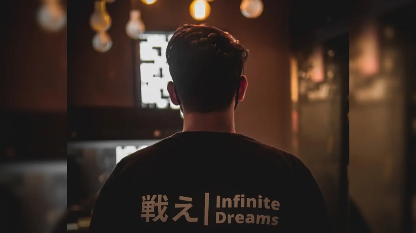 Akshat wearing an Infinite Dreams shirt in a cinema