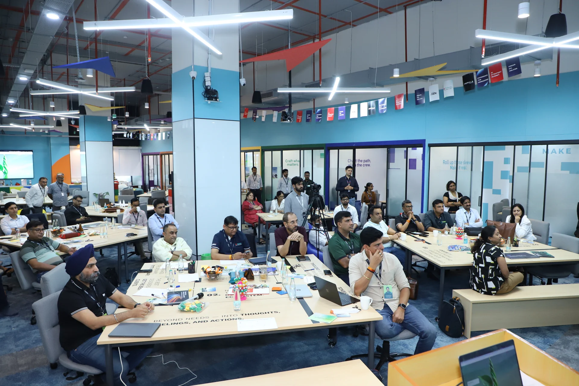 The full workshop floor: leadership teams at tables working through their business