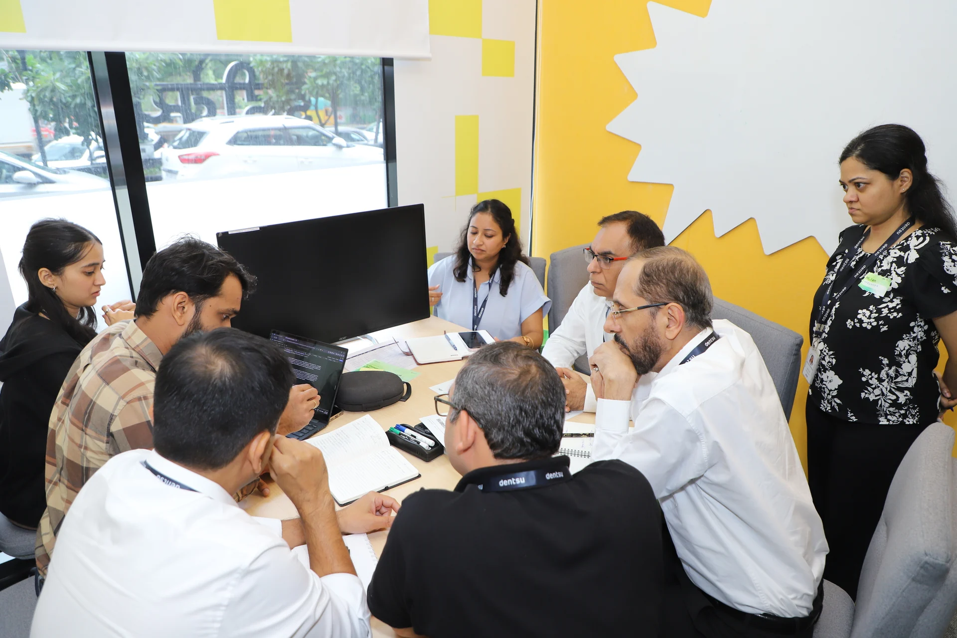 A leadership team working hands-on around a table during design doing