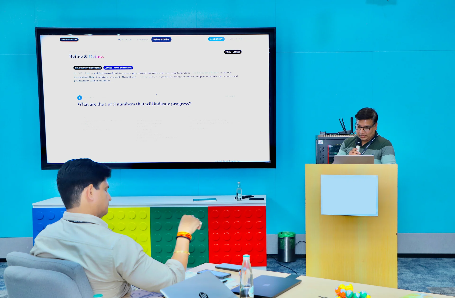 A leader responding to a live prompt on the big screen during the workshop